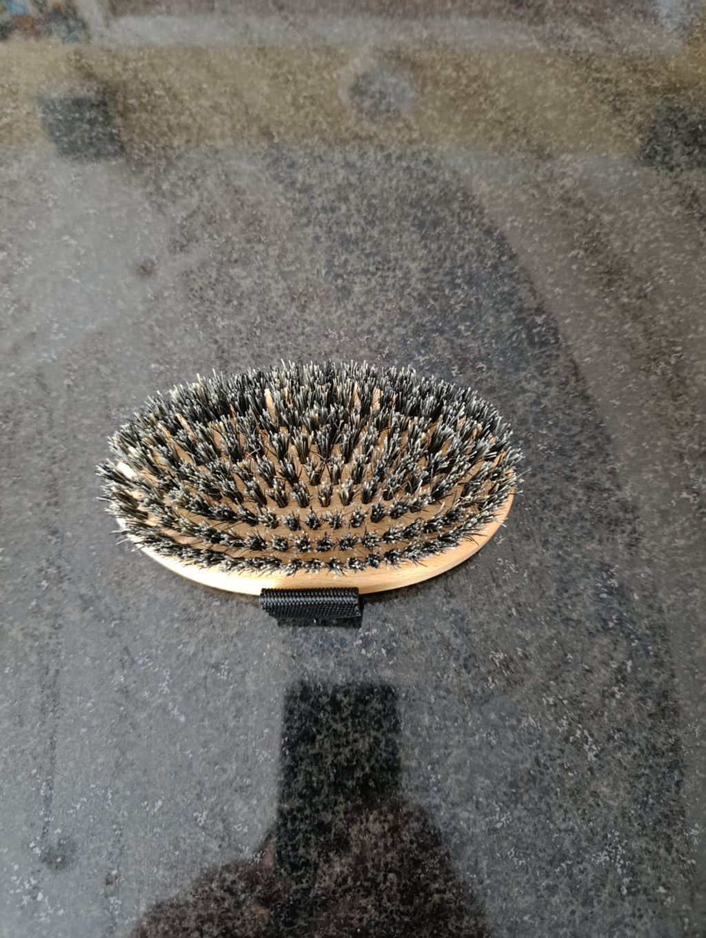 Hairbrush with bristles on a textured surface