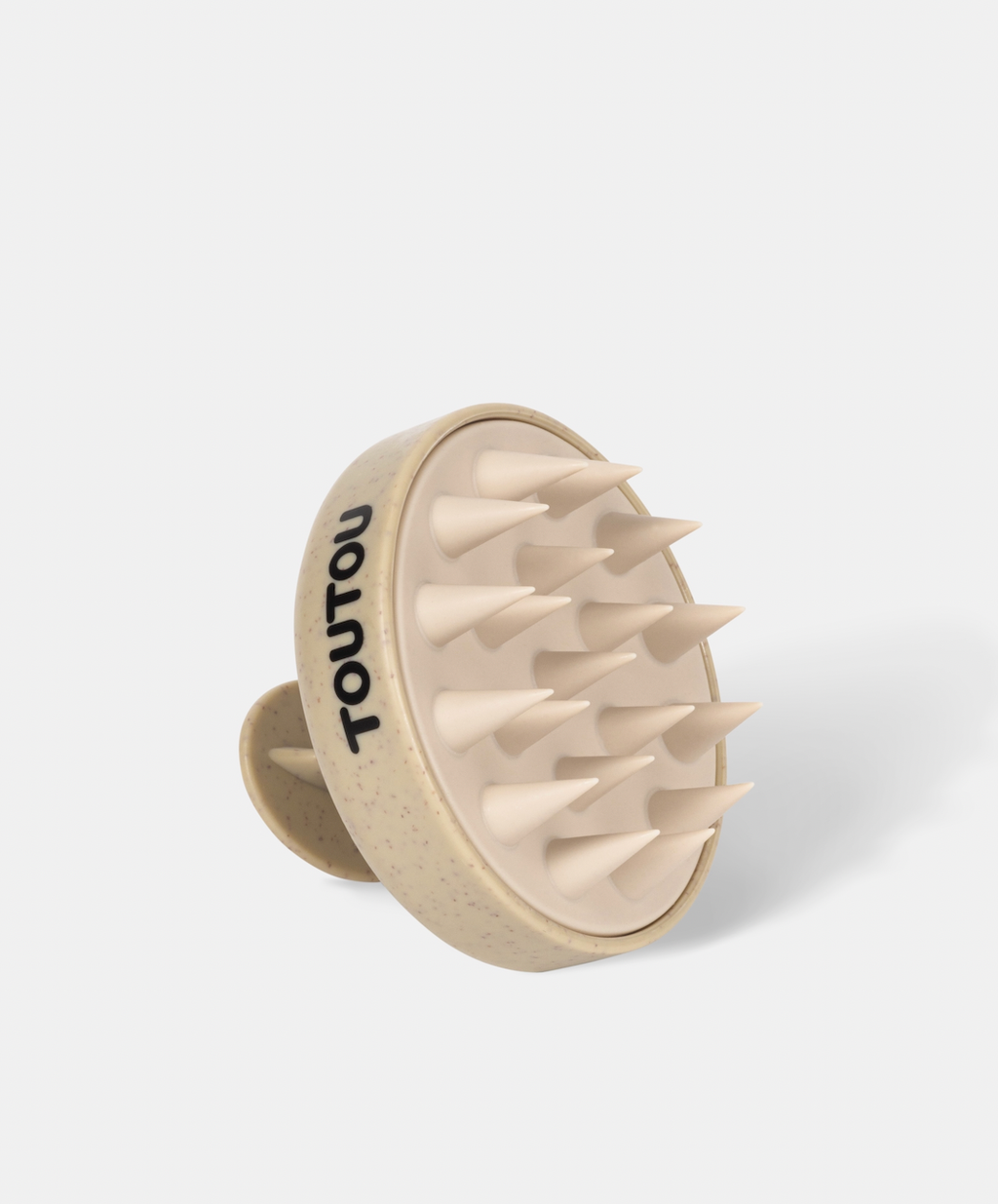 Beige scalp massager with 'TOUTOU' branding on a white background