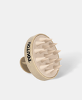 Beige scalp massager with 'TOUTOU' branding on a white background
